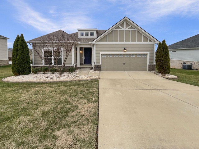 view of front facade with a front yard, a garage, and central air condition unit