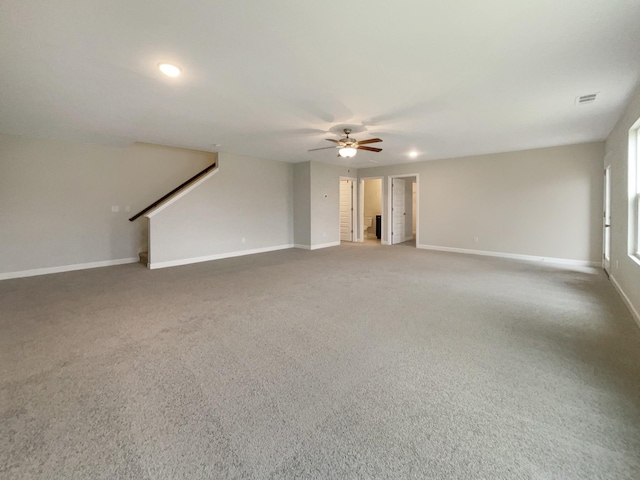 unfurnished living room with carpet flooring and ceiling fan