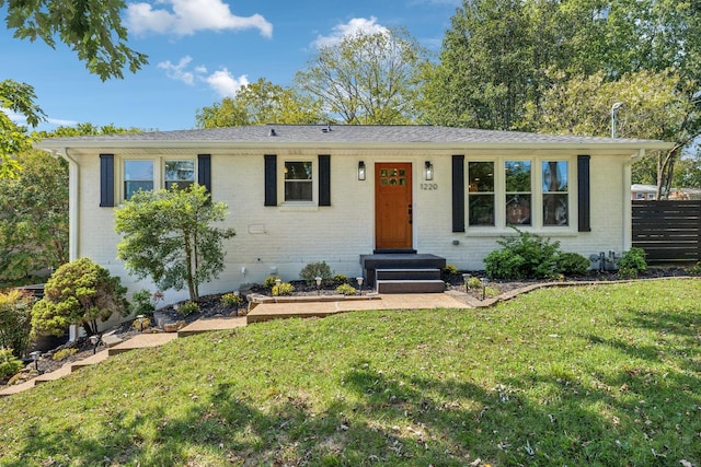 single story home featuring a front lawn