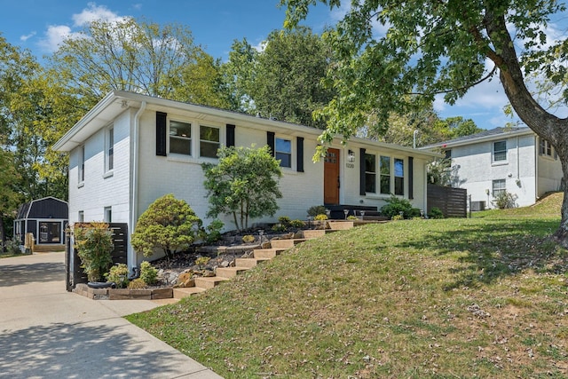 single story home featuring a shed and a front yard