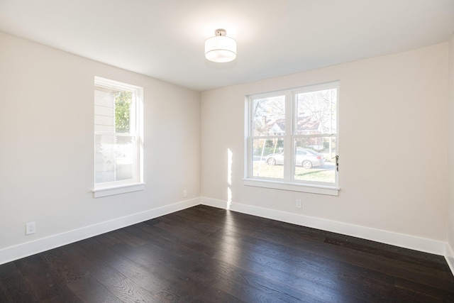 unfurnished room with dark hardwood / wood-style floors