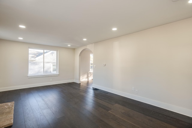 spare room with dark wood-type flooring