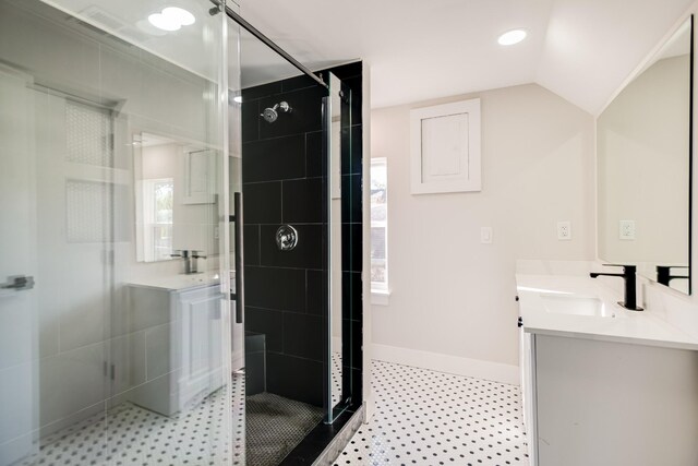 bathroom featuring vanity, an enclosed shower, and vaulted ceiling