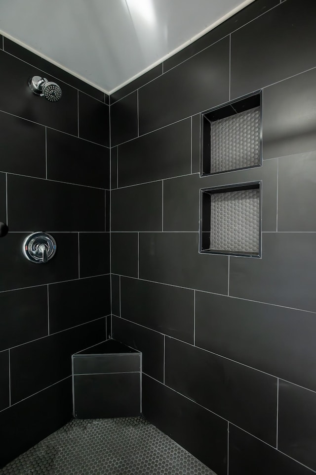 bathroom with a tile shower