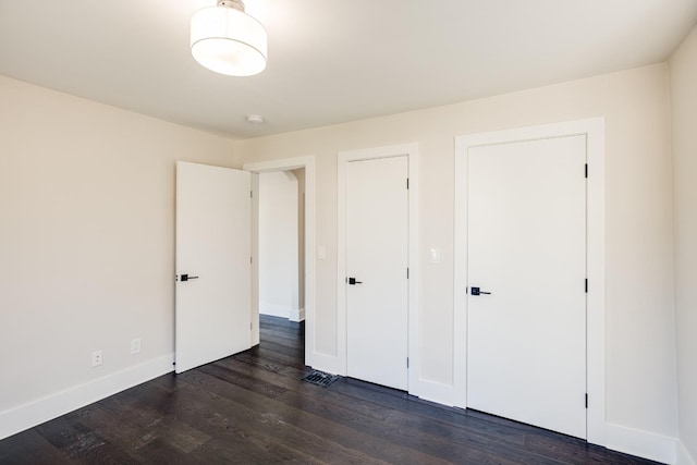 unfurnished bedroom featuring dark hardwood / wood-style flooring