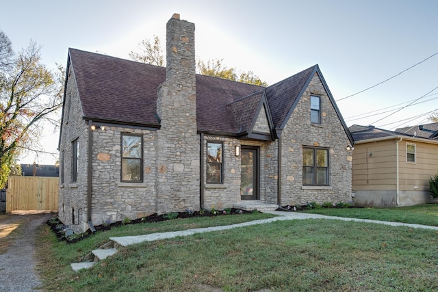 english style home with a front lawn