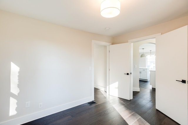 empty room with dark wood-type flooring