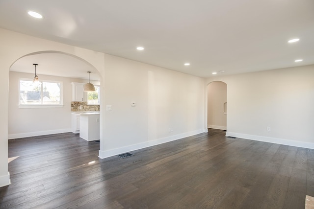 empty room with dark hardwood / wood-style flooring