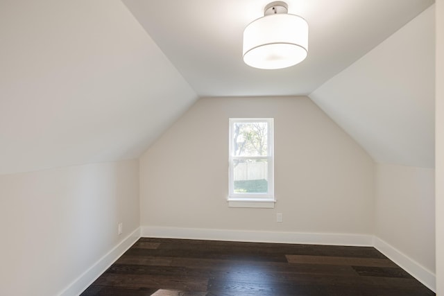 bonus room featuring lofted ceiling and dark hardwood / wood-style floors