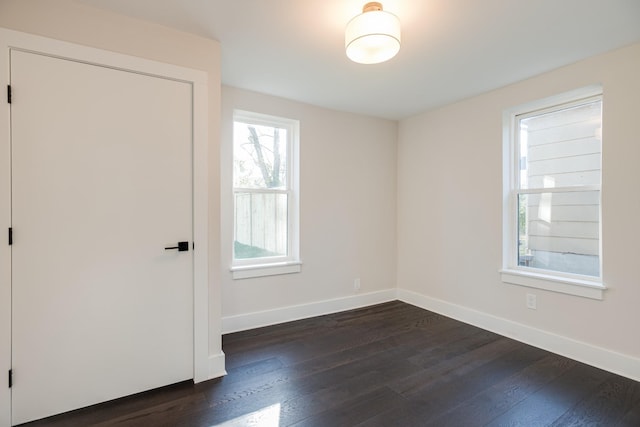 empty room featuring dark hardwood / wood-style flooring