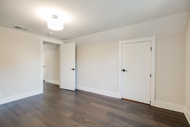 empty room featuring dark hardwood / wood-style flooring