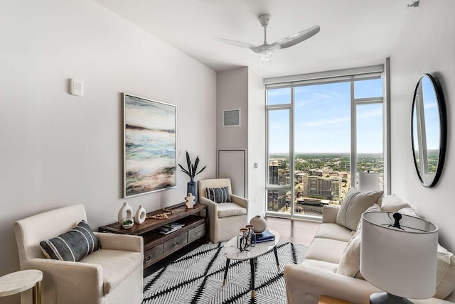 living room with a wall of windows and ceiling fan