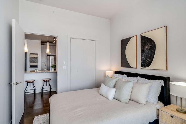 bedroom with dark hardwood / wood-style floors