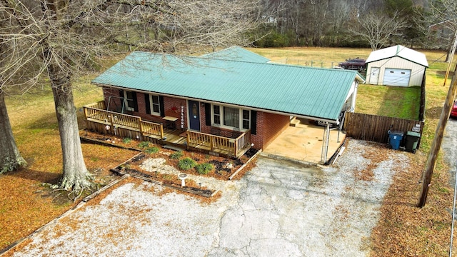 view of front facade with an outbuilding, a garage, and a carport