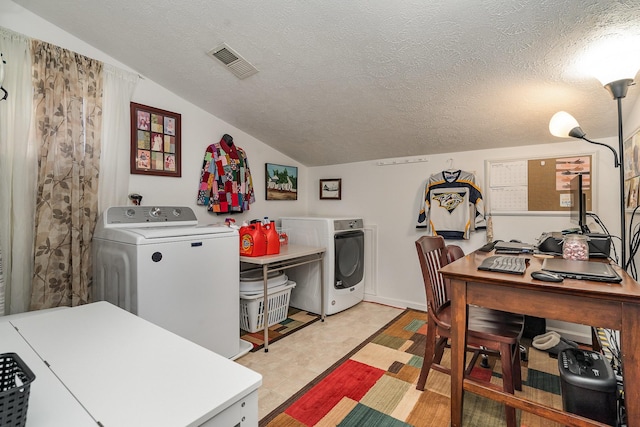 washroom featuring a textured ceiling and washing machine and clothes dryer