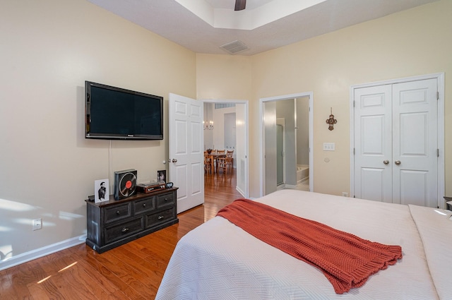 bedroom with a closet, hardwood / wood-style flooring, and ceiling fan