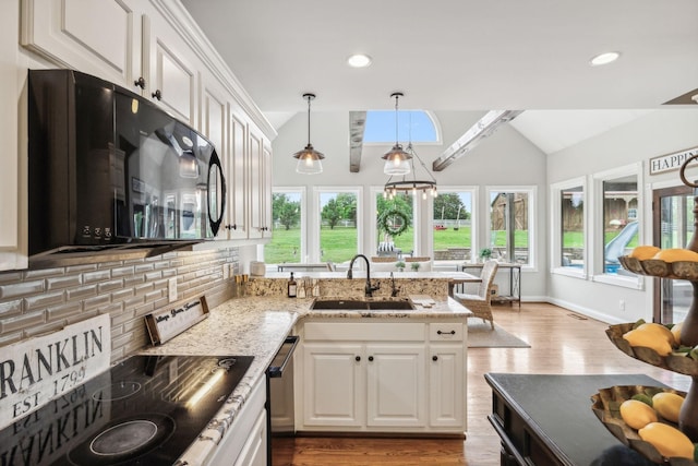 kitchen featuring vaulted ceiling with beams, white cabinetry, and sink