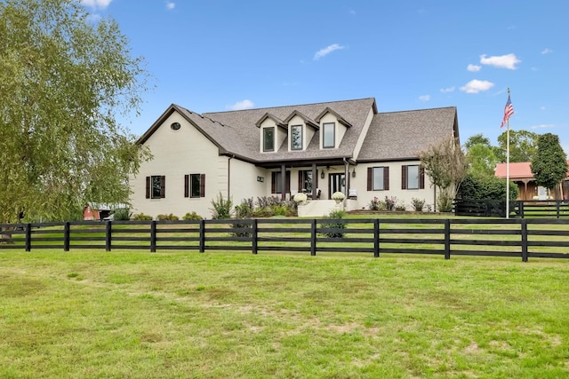 cape cod house featuring a front yard