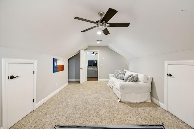 sitting room featuring ceiling fan, lofted ceiling, and light carpet