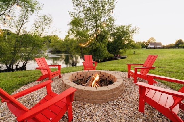 view of patio featuring a water view and an outdoor fire pit