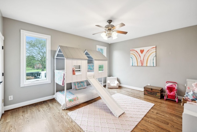 bedroom with light wood-type flooring and ceiling fan