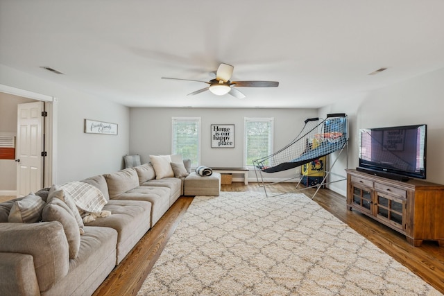 living room featuring hardwood / wood-style floors and ceiling fan