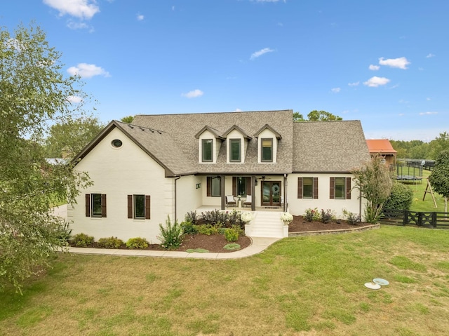 cape cod house with a front lawn