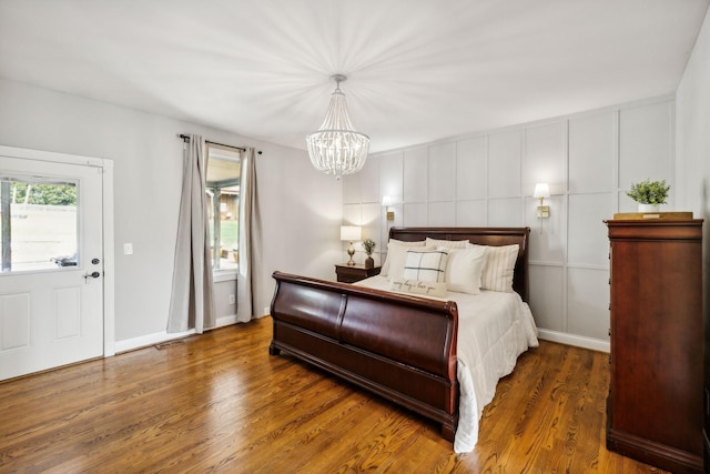 bedroom featuring dark hardwood / wood-style floors and a notable chandelier