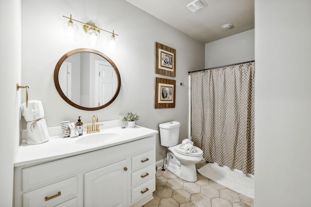 bathroom with vanity, toilet, and curtained shower