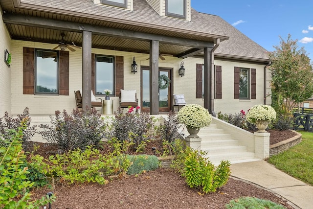 entrance to property featuring covered porch and ceiling fan