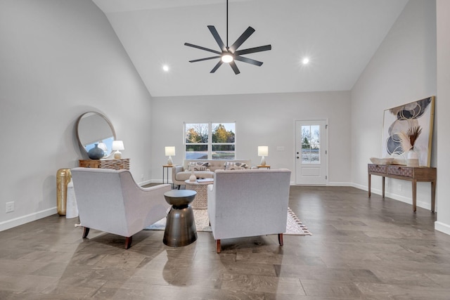 living room with hardwood / wood-style floors, ceiling fan, and high vaulted ceiling