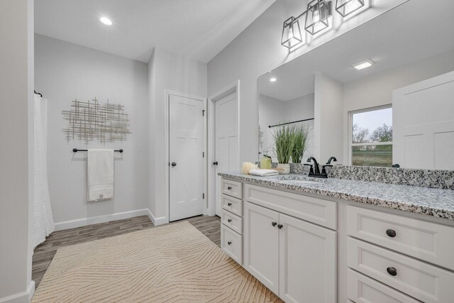 bathroom featuring vanity and wood-type flooring