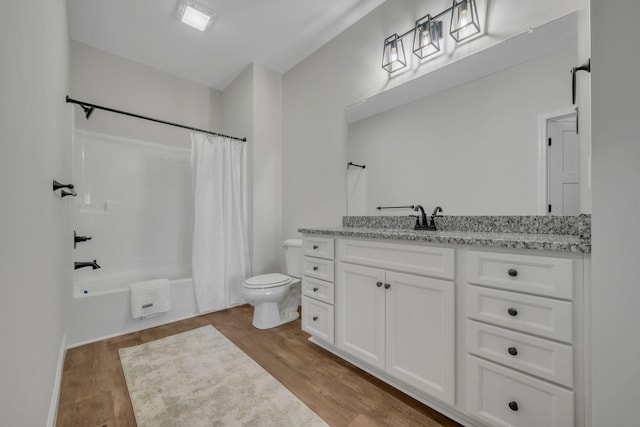 full bathroom featuring vanity, toilet, wood-type flooring, and shower / tub combo with curtain