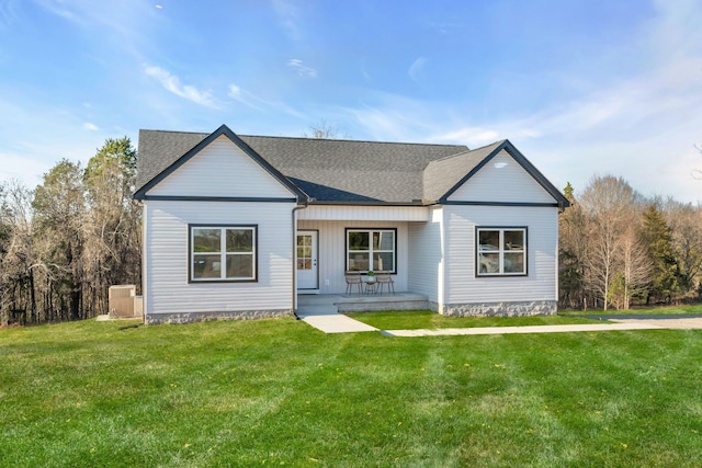 ranch-style home featuring covered porch and a front lawn