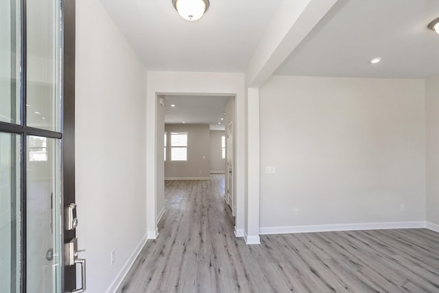 corridor with light wood-type flooring