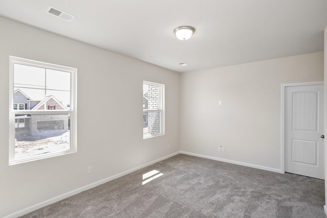 unfurnished room featuring carpet