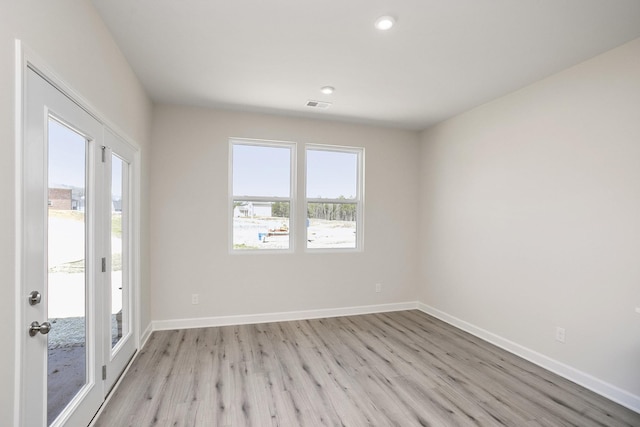 spare room featuring light hardwood / wood-style flooring