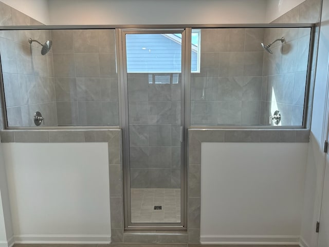 bathroom featuring a shower with shower door