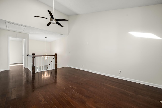 empty room with vaulted ceiling, dark hardwood / wood-style floors, and ceiling fan