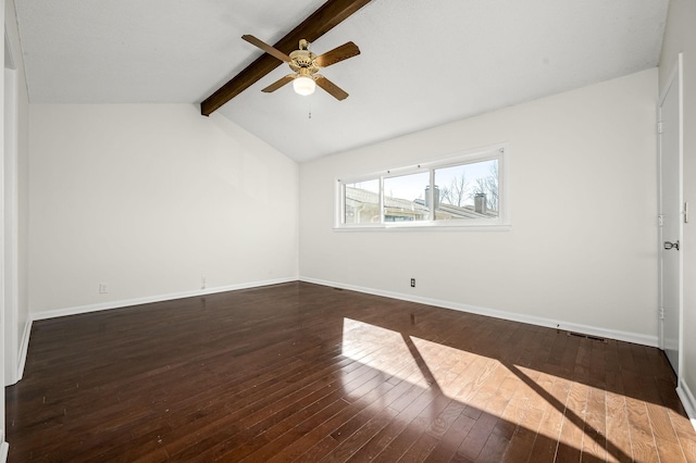 empty room featuring ceiling fan, dark hardwood / wood-style floors, and vaulted ceiling with beams