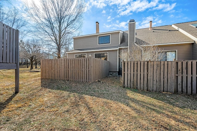 rear view of property with a lawn