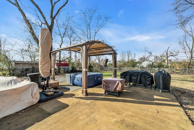 view of patio with a hot tub and a grill