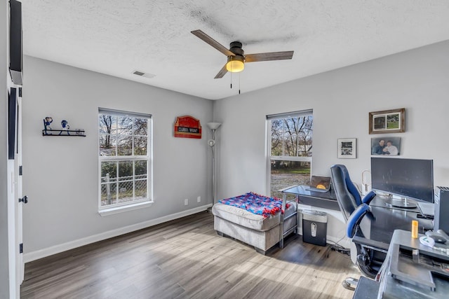 office area featuring ceiling fan, dark hardwood / wood-style floors, and a textured ceiling