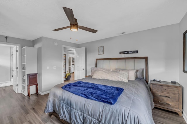 bedroom with ceiling fan and hardwood / wood-style flooring