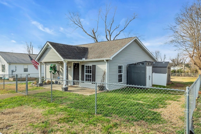 view of front of home featuring a storage unit and a front lawn