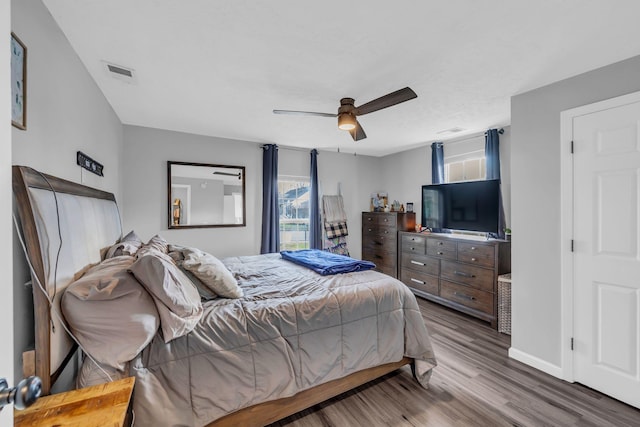 bedroom with hardwood / wood-style floors and ceiling fan