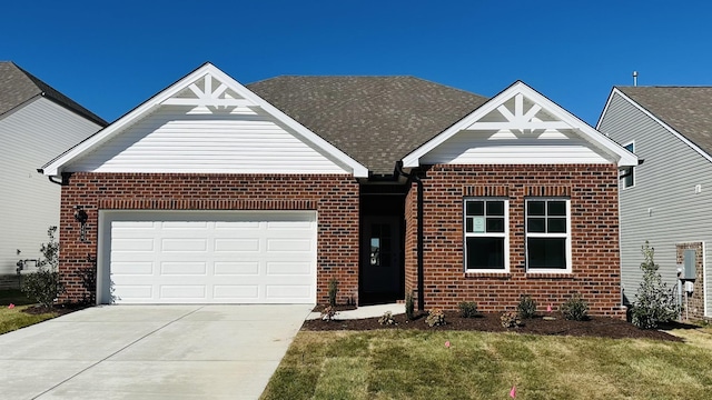 view of front of home featuring a front yard and a garage