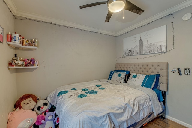 bedroom with ceiling fan, hardwood / wood-style floors, and ornamental molding