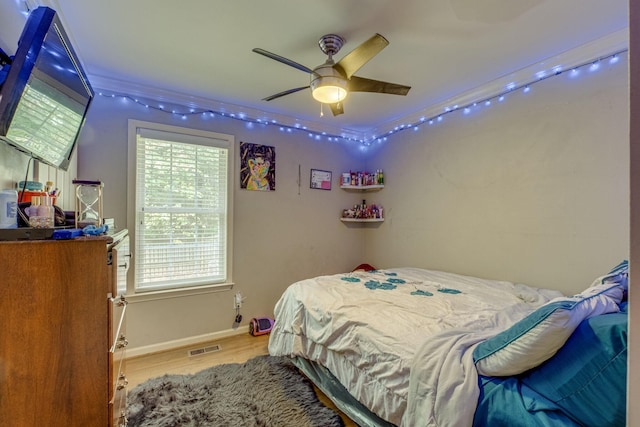 bedroom with hardwood / wood-style flooring and ceiling fan