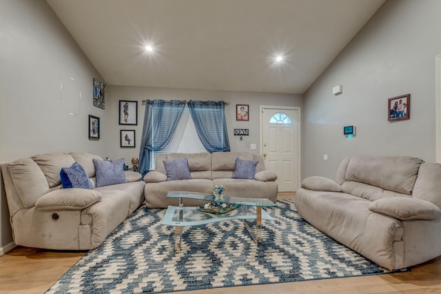 living room with hardwood / wood-style floors and lofted ceiling